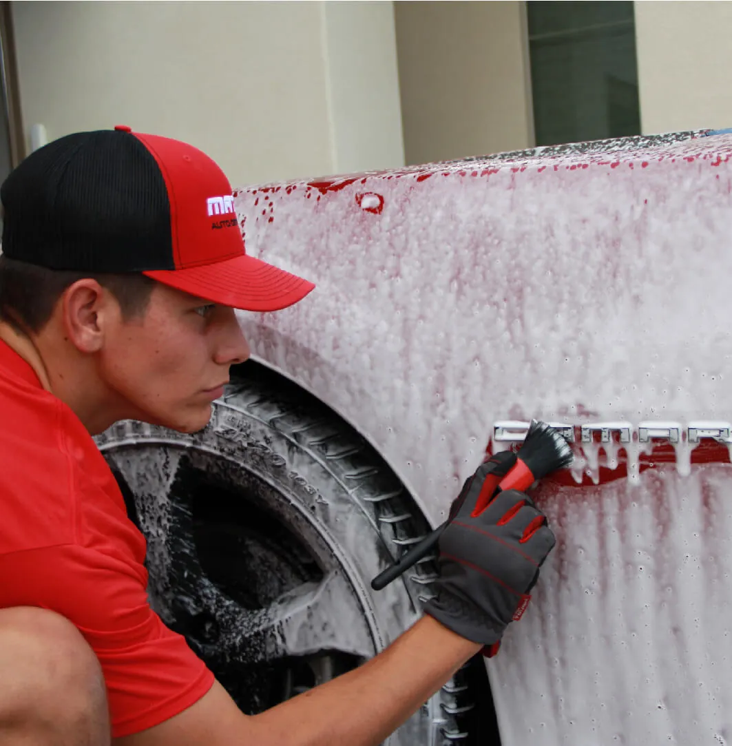 A technician scrubbing a foamed wheel