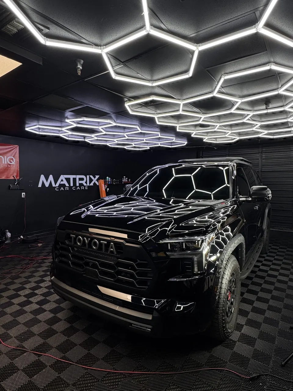 A black Toyota truck on the checkered floor of the Matrix studio